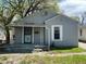 Charming home featuring gray siding, covered front porch, and well-maintained yard at 3541 Orchard Ave, Indianapolis, IN 46218