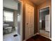 Hallway view to bathroom with tile floor and tub, kitchen with white appliances at 3541 Orchard Ave, Indianapolis, IN 46218