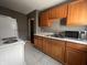 Kitchen with wood cabinets, white countertops, and appliances at 3541 Orchard Ave, Indianapolis, IN 46218