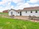 Backyard with patio and half-walls adjoins a light-colored home with a dark roof and trim at 389 E State Road 42, Mooresville, IN 46158