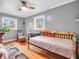 Bright bedroom with wood floors, a ceiling fan, and two windows offers a cozy and inviting atmosphere at 389 E State Road 42, Mooresville, IN 46158