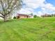 Home with brick accents and light siding set on a large lot with a big tree in the front yard at 389 E State Road 42, Mooresville, IN 46158