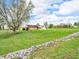 Home with brick accents and light siding set on a large lot with a rock-lined swale in the front yard at 389 E State Road 42, Mooresville, IN 46158