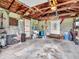 Functional garage with exposed wood beams, cinder block walls, electrical panel, and ample space for storage and projects at 389 E State Road 42, Mooresville, IN 46158