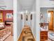 Bright hallway with hardwood floors connects a living area and another room, enhanced by natural light and neutral decor at 389 E State Road 42, Mooresville, IN 46158