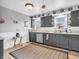This lovely kitchen features gray cabinets, stainless steel appliances, and plenty of natural light at 389 E State Road 42, Mooresville, IN 46158