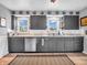 This lovely kitchen features gray cabinets, stainless steel appliances, and plenty of natural light at 389 E State Road 42, Mooresville, IN 46158