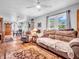 Inviting living room with hardwood floors, ceiling fan, and large windows, providing ample natural light at 389 E State Road 42, Mooresville, IN 46158