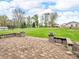 Brick patio with half-walls overlooks a wide, grassy backyard and a rural landscape beyond at 389 E State Road 42, Mooresville, IN 46158