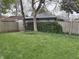 Backyard includes mature trees, climbing ivy and a wooden fence surrounding a lush lawn at 421 W 44Th St, Indianapolis, IN 46208