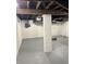 Finished basement with painted support column and exposed utilities at 421 W 44Th St, Indianapolis, IN 46208