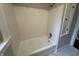 Bathroom with tiled walls and floors features a modern bathtub and shower head at 421 W 44Th St, Indianapolis, IN 46208