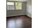 Bedroom with two windows offering natural light and hardwood floors at 421 W 44Th St, Indianapolis, IN 46208