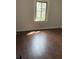 Bedroom with natural light from a window highlighting the fresh paint and hardwood floors at 421 W 44Th St, Indianapolis, IN 46208
