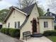 Charming home with a decorative wrought-iron door and manicured bushes with a bench at 421 W 44Th St, Indianapolis, IN 46208