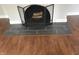 Classic fireplace with wood logs, tile hearth, and decorative screen at 421 W 44Th St, Indianapolis, IN 46208