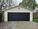 Front view of the beige garage with large, black garage door and small window at 421 W 44Th St, Indianapolis, IN 46208