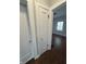 Hallway featuring hardwood floors, detailed trim and access to a bedroom with natural light at 421 W 44Th St, Indianapolis, IN 46208