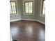 Bright living room with three windows and hardwood floors at 421 W 44Th St, Indianapolis, IN 46208