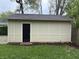 Tan outbuilding with black door and updated landscaping at 421 W 44Th St, Indianapolis, IN 46208