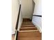 Stairway featuring hardwood steps and white painted walls at 421 W 44Th St, Indianapolis, IN 46208