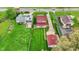 Birds eye view showcasing a home with large green lawn and a detached garage with matching red roof at 429 E Main St, Whiteland, IN 46184