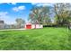 Expansive backyard featuring lush lawn, mature trees and a detached garage at 429 E Main St, Whiteland, IN 46184