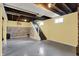 Open basement with painted ceiling and walls, wood accent wall and staircase at 429 E Main St, Whiteland, IN 46184
