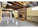 Spacious basement featuring concrete floors, exposed ceiling and brick fireplace at 429 E Main St, Whiteland, IN 46184