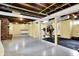 Large finished basement with a brick fireplace, cabinetry, and workout area at 429 E Main St, Whiteland, IN 46184