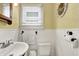 Quaint bathroom with a classic sink, toilet, and fresh white accents, combining functionality with a clean and tidy aesthetic at 429 E Main St, Whiteland, IN 46184