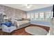 Bedroom featuring a brick wall, hardwood floors, three windows, and a brick wall at 429 E Main St, Whiteland, IN 46184