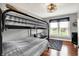 Bedroom with bunk bed, hardwood floors, window, rug, ceiling fan and mini refrigerator at 429 E Main St, Whiteland, IN 46184