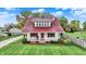 Charming two-story home featuring a covered front porch and manicured landscaping at 429 E Main St, Whiteland, IN 46184