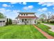 Charming two-story home with a red roof, swing porch, and well-manicured lawn at 429 E Main St, Whiteland, IN 46184