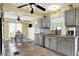 Updated kitchen with stainless appliances and gray cabinets adjacent to dining area with seating and natural light at 429 E Main St, Whiteland, IN 46184