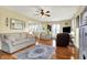 Spacious living room with hardwood floors, ceiling fan, large windows, and traditional furniture at 429 E Main St, Whiteland, IN 46184