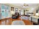 Bright living room with hardwood floors, large windows, ceiling fan, and traditional furniture at 429 E Main St, Whiteland, IN 46184