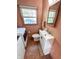 Cozy half-bathroom features modern white sink with wood trim and patterned wall paper at 4305 Lincoln Rd, Indianapolis, IN 46228