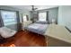 Inviting bedroom with hardwood floors, a cozy bed, and bright natural light from the windows at 4305 Lincoln Rd, Indianapolis, IN 46228