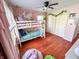' bedroom features wood floors, natural light, bunk beds and pink walls at 4305 Lincoln Rd, Indianapolis, IN 46228