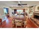 Open concept dining and living rooms with hardwood floors, fireplace, and a ceiling fan at 4305 Lincoln Rd, Indianapolis, IN 46228