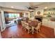 Open concept dining and living rooms with hardwood floors, fireplace, and a ceiling fan at 4305 Lincoln Rd, Indianapolis, IN 46228