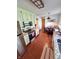 Galley kitchen with white cabinets, stainless appliances, brick floor and granite countertops at 4305 Lincoln Rd, Indianapolis, IN 46228