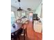 Galley kitchen with white cabinets, stainless appliances, brick floor and granite countertops at 4305 Lincoln Rd, Indianapolis, IN 46228