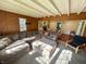 Comfortable living room with a large sectional sofa, wood paneling, and a bright airy feel at 4305 Lincoln Rd, Indianapolis, IN 46228