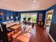 Bright living room with hardwood floors, guitars, and large windows that offer abundant light at 4305 Lincoln Rd, Indianapolis, IN 46228