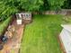 Aerial view highlighting a spacious backyard featuring a screened-in structure, garden boxes, and a pristine lawn at 4904 Kessler Blvd N Dr, Indianapolis, IN 46228