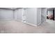 Expansive finished basement area with access to a bathroom and staircase at 4904 Kessler Blvd N Dr, Indianapolis, IN 46228