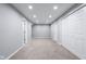 Spacious unfinished basement with multiple storage closets and neutral carpet and walls at 4904 Kessler Blvd N Dr, Indianapolis, IN 46228